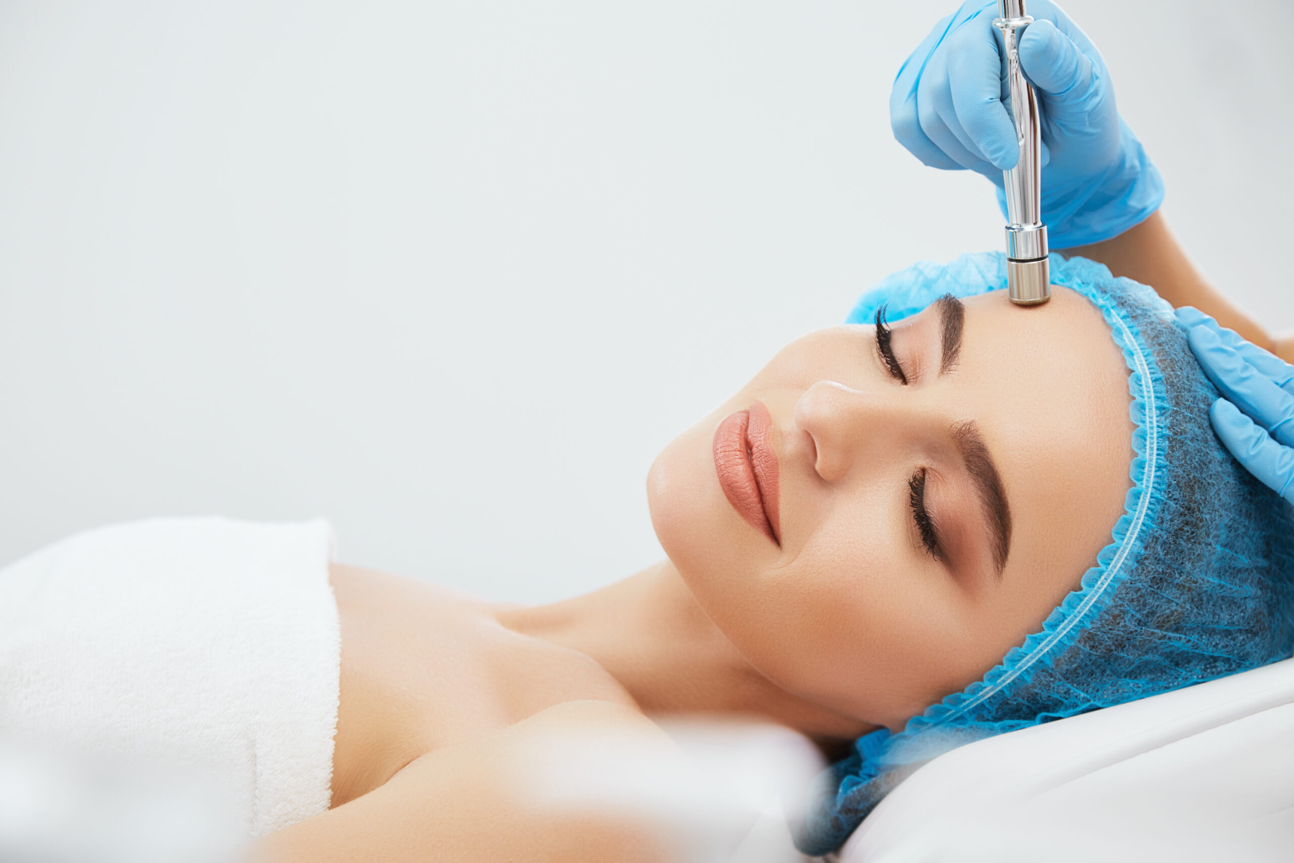 Model lying on procedure of microdermabrasia microdermabrasia scaled - Microdermabrasion